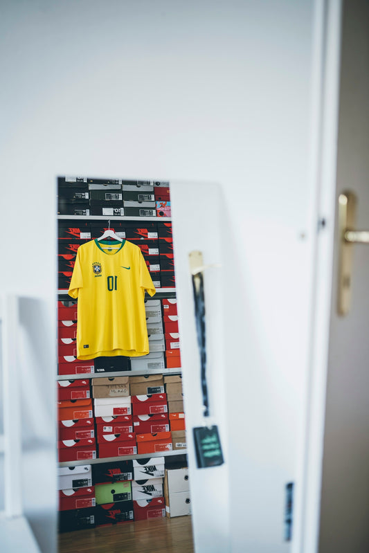 yellow jersey shirt hanging on shelf