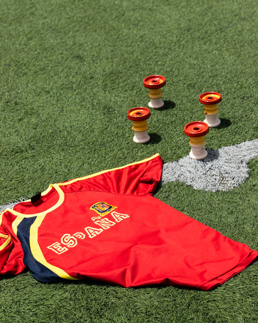 a red and yellow shirt on the grass