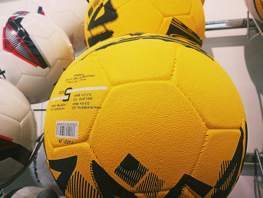 a group of soccer balls sitting next to each other
