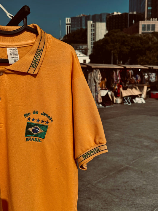 a yellow shirt with a green and white logo on it
