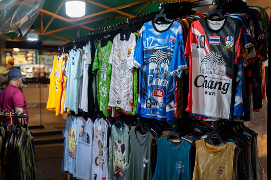 A man standing in front of a display of shirts