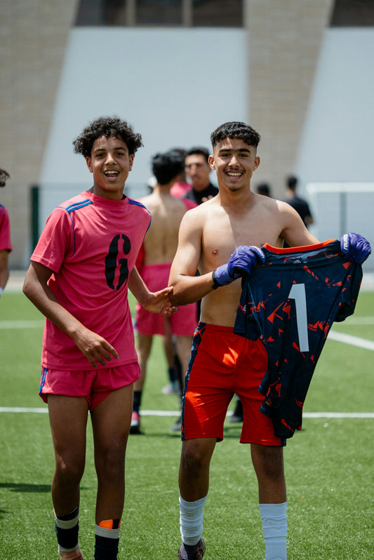 Soccer players pose happily after a game.